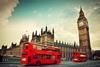 London, the UK. Red bus in motion and Big Ben